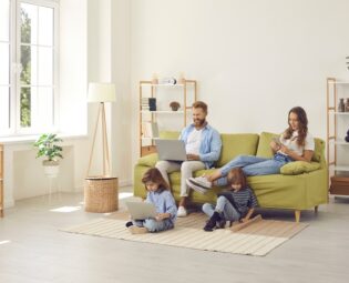 Family relaxing in their living room while using fast home internet