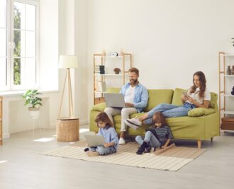 Family relaxing in their living room while using fast home internet