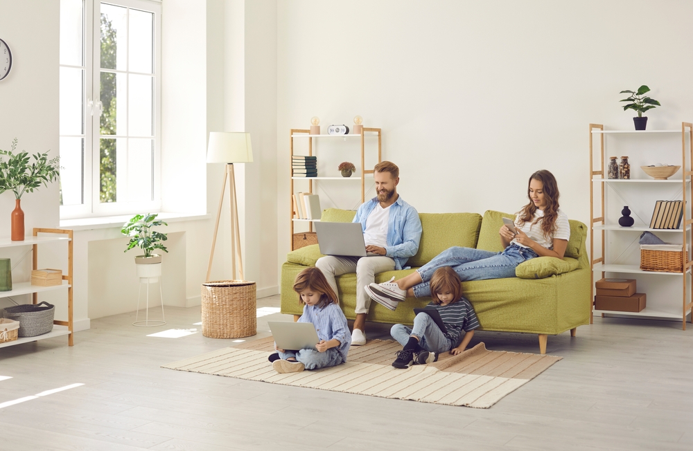 Family,Sitting,In,Cozy,Spacious,Scandinavian,Livingroom,With,Wireless,Internet